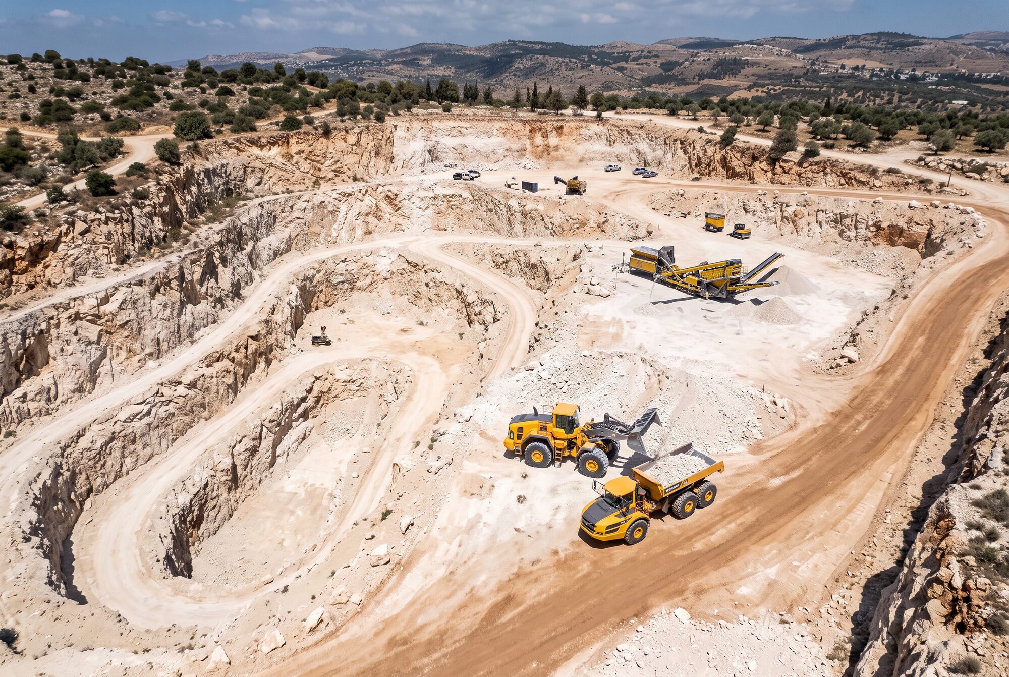 Aerial of a limestone quarry with loader and hauler